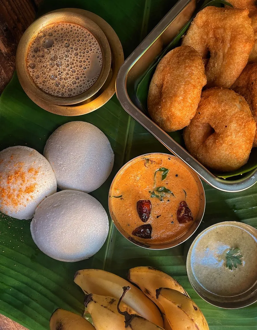 Idli, vada and filter coffee on a banana leaf