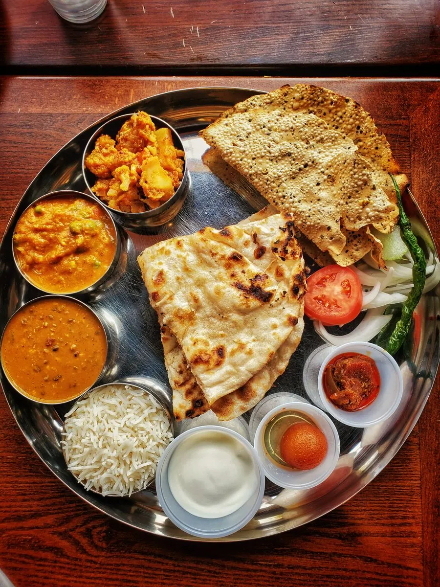 A North Indian thali with naan, dal, paneer and rice